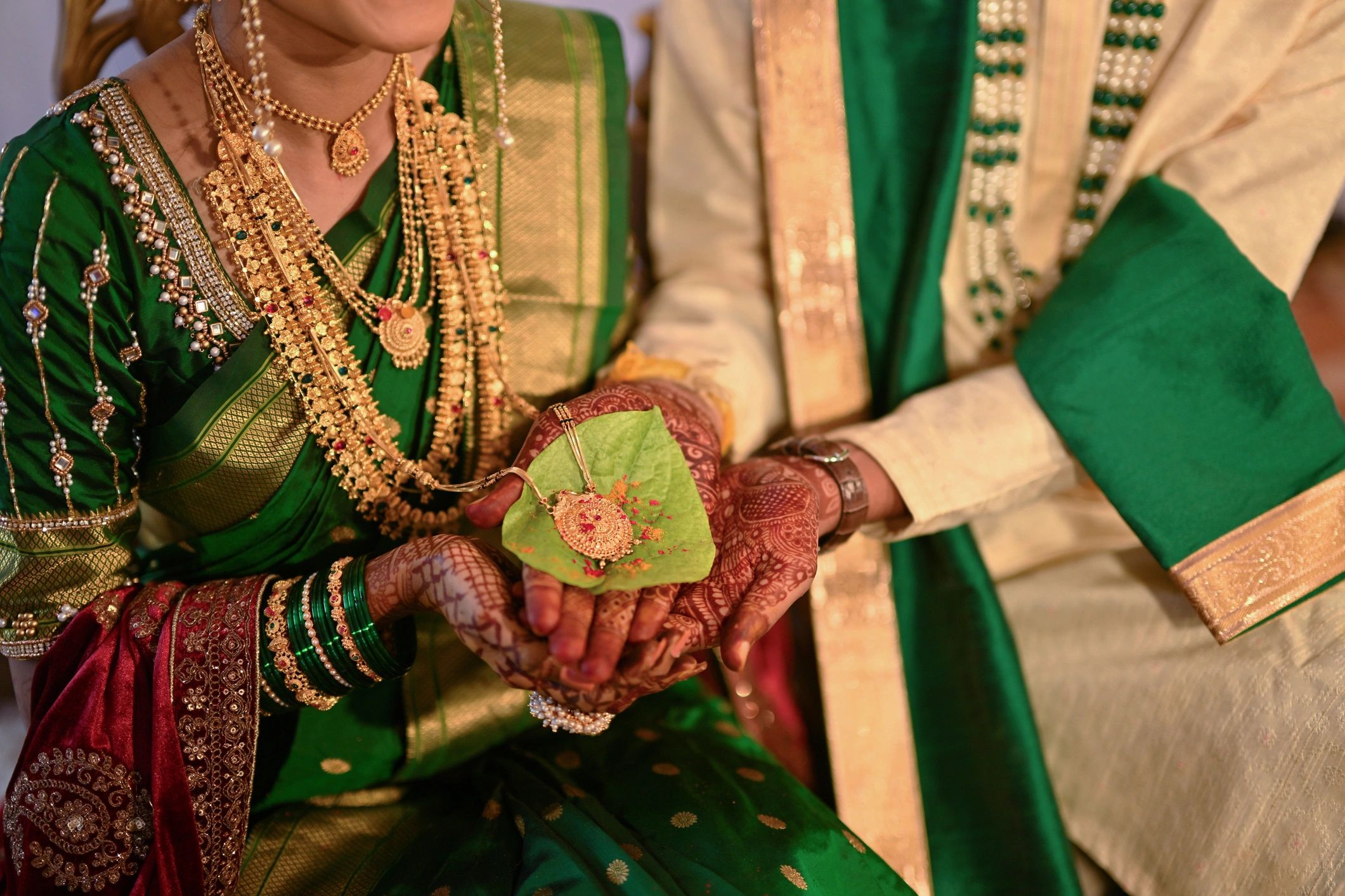 Close-up of hands holding wedding jewelry detail